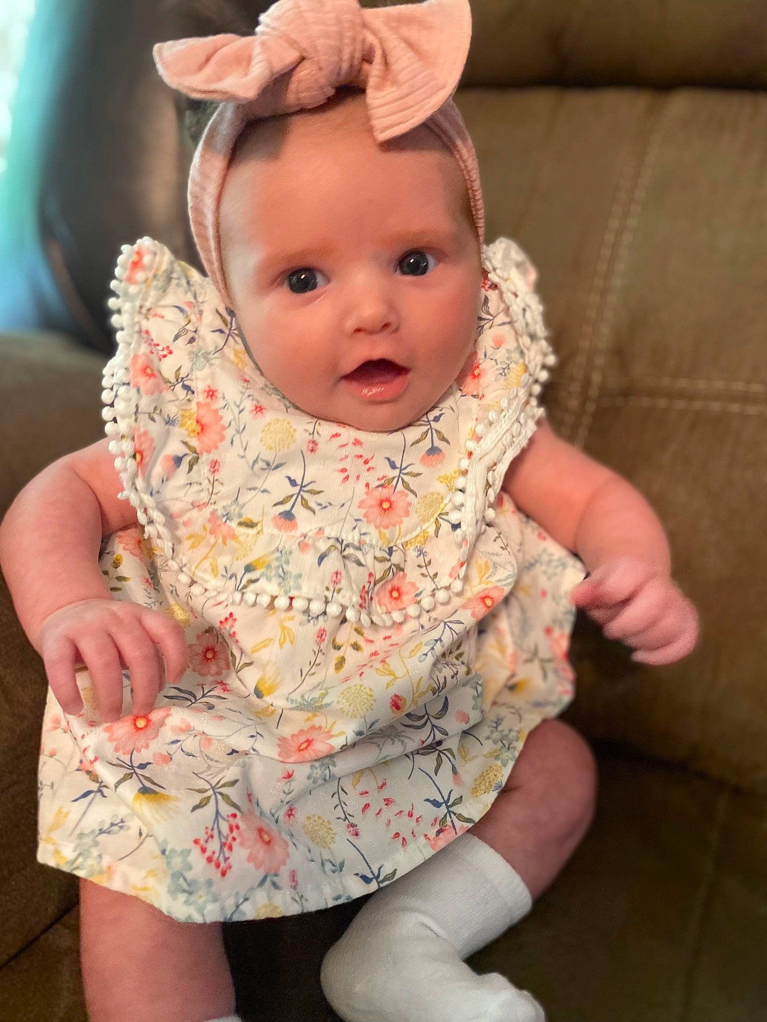Oaklee is registered to the contest to win money with this photo: baby, baby_toddler_clothing, cheek, child, dress, finger, happy, head, headband, headpiece, human_body, iris, jewellery, lip, pattern, person, pink, skin, sleeve, surprise