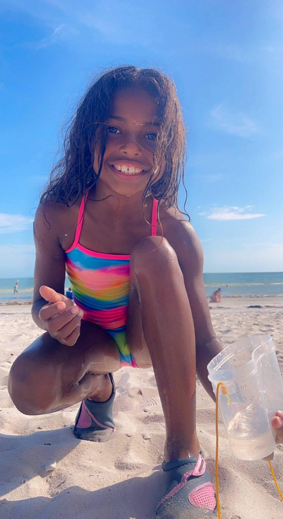 Kiara is registered to the contest to win money with this photo: beach, cloud, flip_flops, fun, hair, hairstyle, happy, human_leg, joy, leg, leisure, natural_environment, people_in_nature, people_on_beach, person, sand, sky, smile, sunlight, swimwear