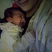 Giulia participe au concours pour gagner de l'argent avec cette photo : baby, infant, smiling, sleeping, adult, blanket, clothing, closeup, cuddle, comfort, face, hand, indoors, person, portrait, rest, soft, warm, tender, love