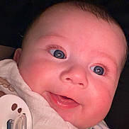 Elio is registered to the contest to win money with this photo: baby, close_up, smiling, blue_eyes, cheeks, face, pacifier, cloth, hand, infant, cute, skin, portrait, person, child, newborn, expression, happy, indoors, soft_light