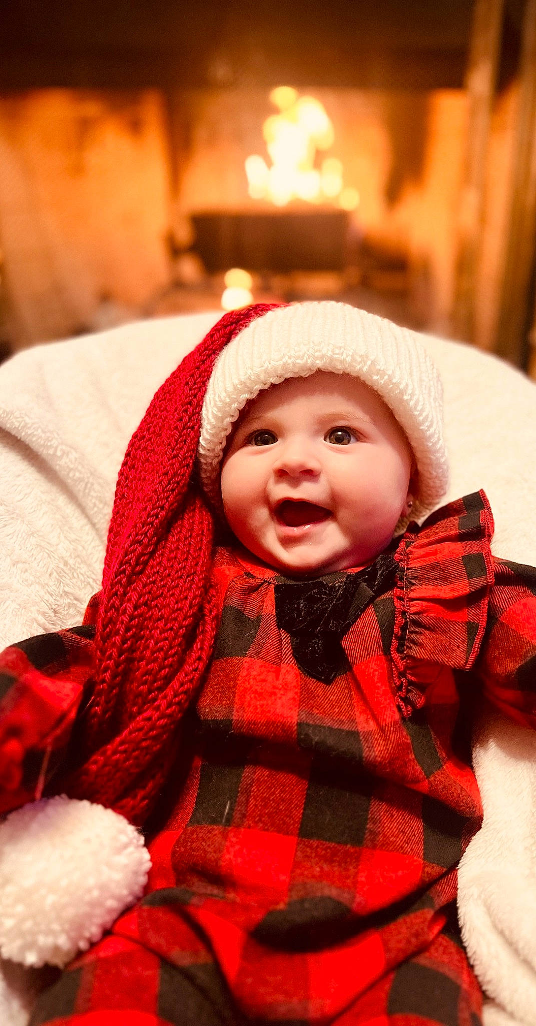 Hollis is registered to the contest to win money with this photo: baby, baby_toddler_clothing, cap, cheek, child, collar, comfort, event, face, happy, headgear, headwear, knit_cap, outerwear, pattern, person, plaid, sleeve, smile, tartan