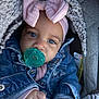 baby, pacifier, blue_eyes, headband, bow, denim_jacket, blanket, hand, face, infant, clothing, cute, portrait, close_up, cozy, warm, child, indoors, soft_texture, person