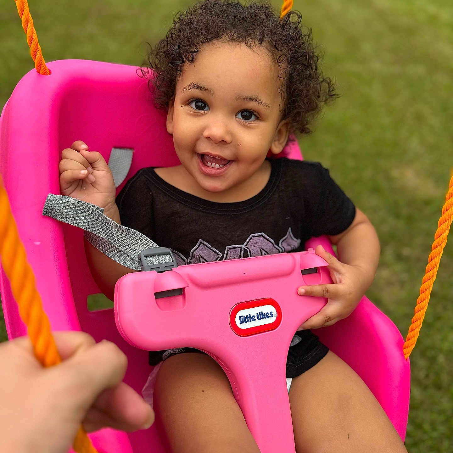 Caliyah is registered to the contest to win money with this photo: baby, bodypart, face, finger, grass, hand, happy, head, nature, outdoorplayarea, outdoors, park, person, photography, plant, playarea, portrait, smile, swing, toy