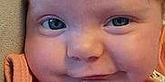 Jensyn joined the competition — help win amazing prizes! baby, infant, face, blue_eyes, smile, clothing, peach_outfit, close_up, skin, cheeks, hair, resting, comfort, cute, child, portrait, young, human, indoors, soft