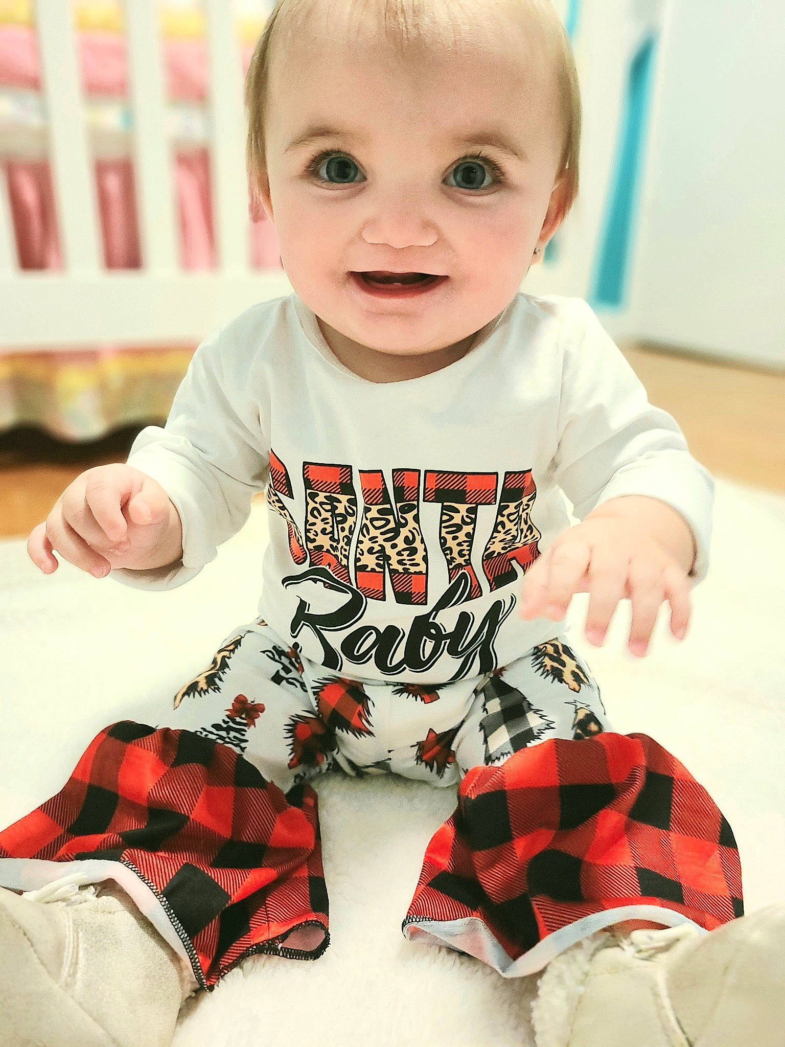 Ellie Mae is registered to the contest to win money with this photo: baby, baby_toddler_clothing, black, child, facial_expression, finger, happy, knee, pattern, person, plaid, red, sleeve, smile, t_shirt, tartan, textile, thigh, toddler, white
