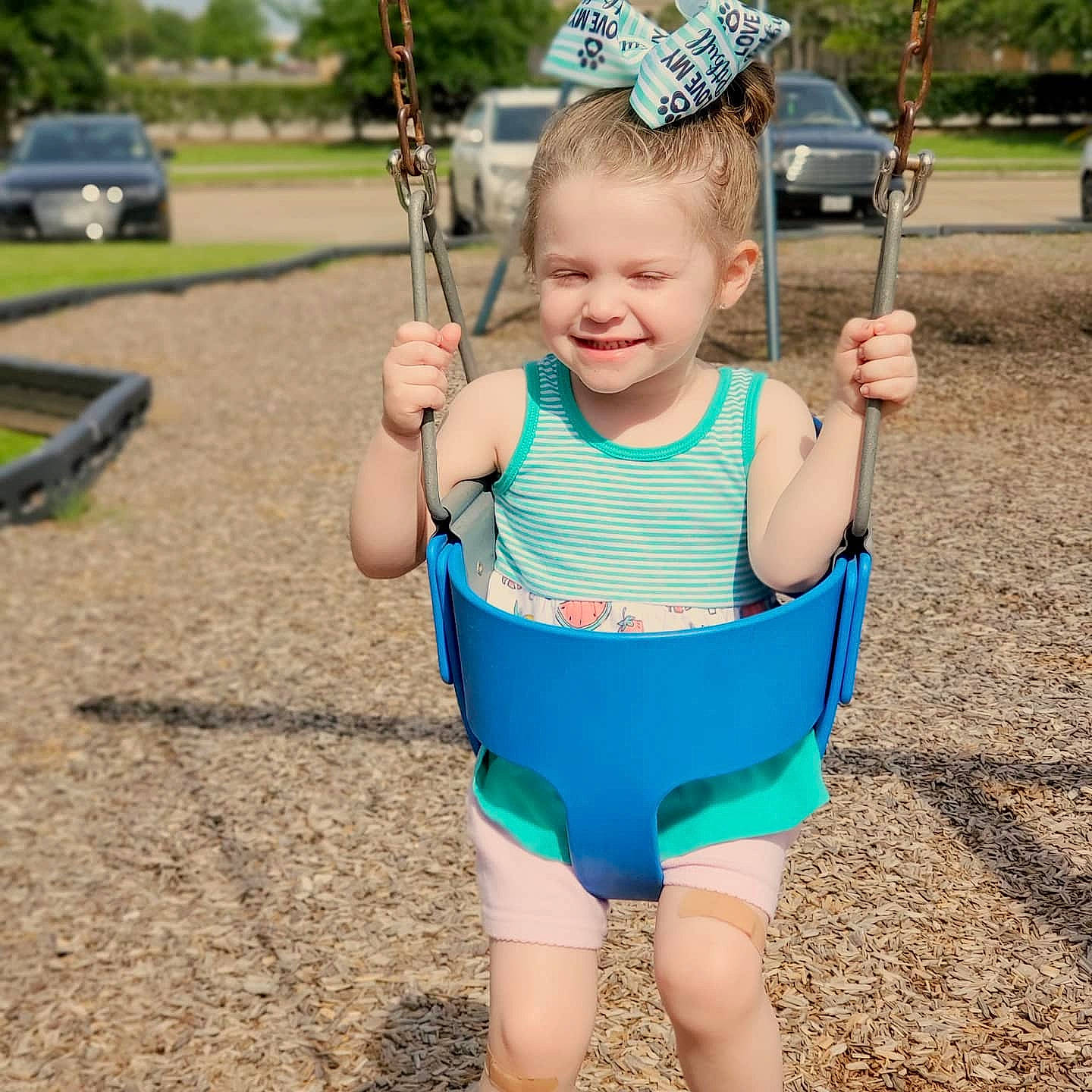 Aizlyn joined the competition — help win amazing prizes! baby, child, fun, joy, outdoor_play_equipment, person, play, playground, public_space, recreation, shorts, smile, summer, swing, toddler, tree, vacation