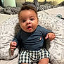 Julian joined the competition — help win amazing prizes! baby, infant, child, cushion, animal_print, bed, blanket, clothing, shorts, top, indoors, curtains, pattern, person, face, hands, feet, expression, sitting, cozy