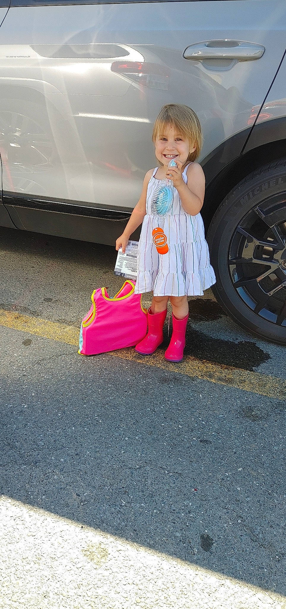 Marissa joined the competition — help win amazing prizes! asphalt, automotive_design, automotive_exterior, automotive_lighting, automotive_tire, bumper, car, dress, hairstyle, joy, land_vehicle, motor_vehicle, person, pink, road_surface, smile, tints_and_shades, tire, toddler, vehicle