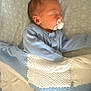 Chester is registered to the contest to win money with this photo: baby, bed, blanket, blue, child, cozy, cute, face, indoors, infant, knit, newborn, onesie, pacifier, peaceful, portrait, rest, sleeping, soft, white
