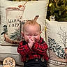 Ashton is registered to the contest to win money with this photo: baby, infant, child, plaid_shirt, black_pants, christmas_tree, holiday_decor, pillows, cozy, indoor, smiling, clapping, cute, festive, red, green, lights, decorations, happy, sitting
