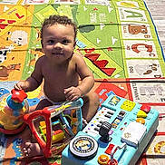 Messiah joined the competition — help win amazing prizes! toddler, child, toy, play_mat, colorful, indoor, floor, piano_toy, ride_on_toy, bumper_car, smiling, curly_hair, baby, playtime, learning, alphabet, animal_pictures, plastic_toys, happy, young_child
