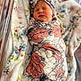 Londyn joined the competition — help win amazing prizes! newborn, baby, swaddle, headband, floral_pattern, blanket, sleeping, infant, soft_texture, cute, cozy, wrapped, indoors, portrait, child, peaceful, closeup, pink, white, floral_design