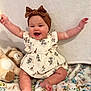 baby, child, smiling, happy, headband, bow, dress, giraffe_pattern, plush_toy, lion, blanket, floral, sitting, arms_up, indoors, cute, infant, soft_texture, portrait, joy