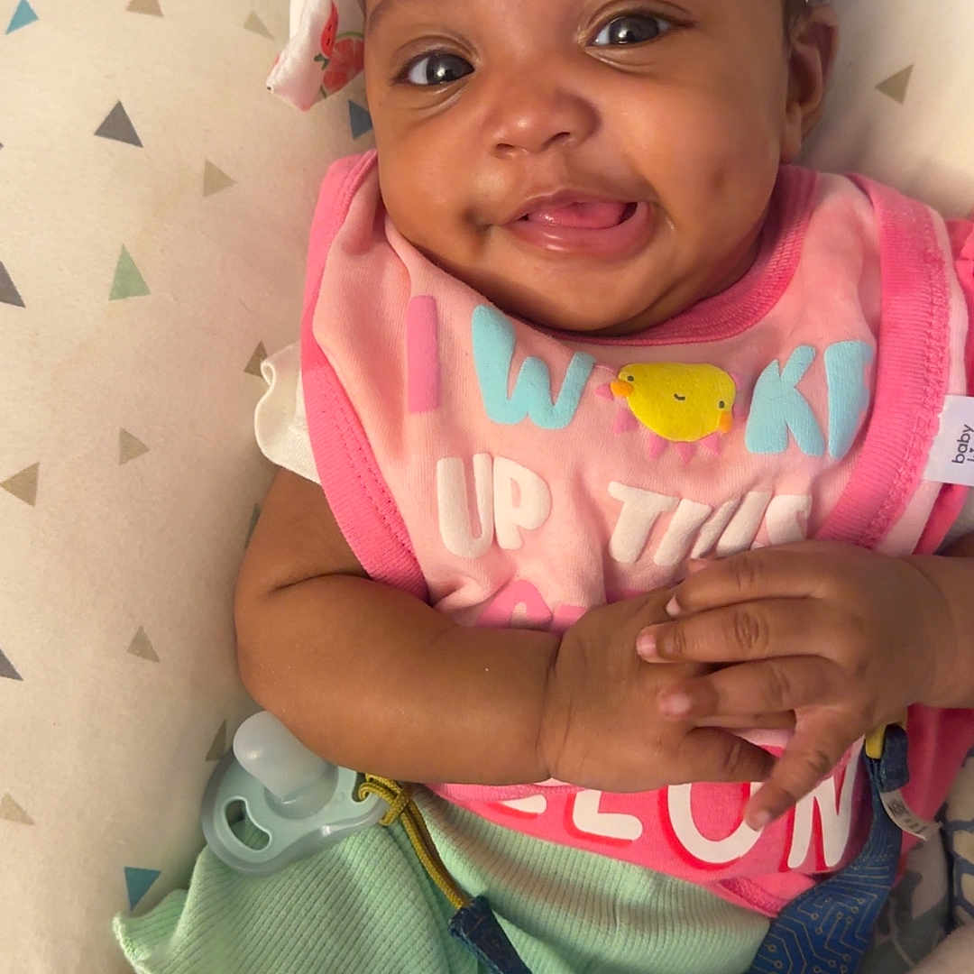 Yanyla Young joined the competition — help win amazing prizes! baby, smiling, headband, dimples, clothing, cushion, patterned, pacifier, hand, tongue, infant, cute, happy, lying_down, indoors, colorful, person, child, closeup, playful