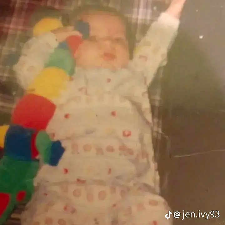 Bradley joined the competition — help win amazing prizes! baby, child, pajamas, plush_toy, caterpillar, blanket, patterned_clothing, socks, lying_down, infant, indoor, soft_toy, cute, sleepwear, young_child, one_arm_up, tiktok_watermark, plaid_pattern, floor, resting