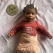Clementine joined the competition — help win amazing prizes! baby, infant, blanket, pink, clothing, face, person, newborn, lying_down, cute, adorable, hair_bow, wooden_sign, text, bedroom, soft_texture, portrait, snuggles, two_months, expression