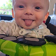 Jaxson joined the competition — help win amazing prizes! baby, tongue_out, smile, indoor, curtains, baby_seat, clothing, face, head, infant, happy, closeup, person, playful, blue_eyes, furniture, soft_light, cute, tongue, polka_dots