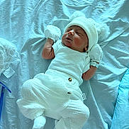 Matthew is registered to the contest to win money with this photo: newborn, baby, sleeping, white_clothing, hat, mittens, blanket, blue_background, infant, cute, soft, cozy, resting, tiny, portrait, indoors, child, lying_down, warm, pom_poms