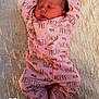 baby, newborn, infant, person, face, sleeping, pink_onesie, princess_text, bed, quilted_blanket, emoji, heart_emoji, crown_emoji, closed_eyes, peaceful, portrait, indoors, soft_lighting, hands_up, tiny_feet