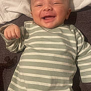 Eynoan participe au concours pour gagner de l'argent avec cette photo : baby, child, cozy, cute, face, happy, head, indoors, infant, lying_down, pajamas, person, portrait, relaxed, skin, small_hand, smiling, soft_surface, striped_clothing, young_child