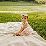baby, child, girl, pink_dress, bow, blanket, grass, lake, outdoor, nature, smile, portrait, sitting, cute, sunlight, greenery, young_child, headband, happy, summer