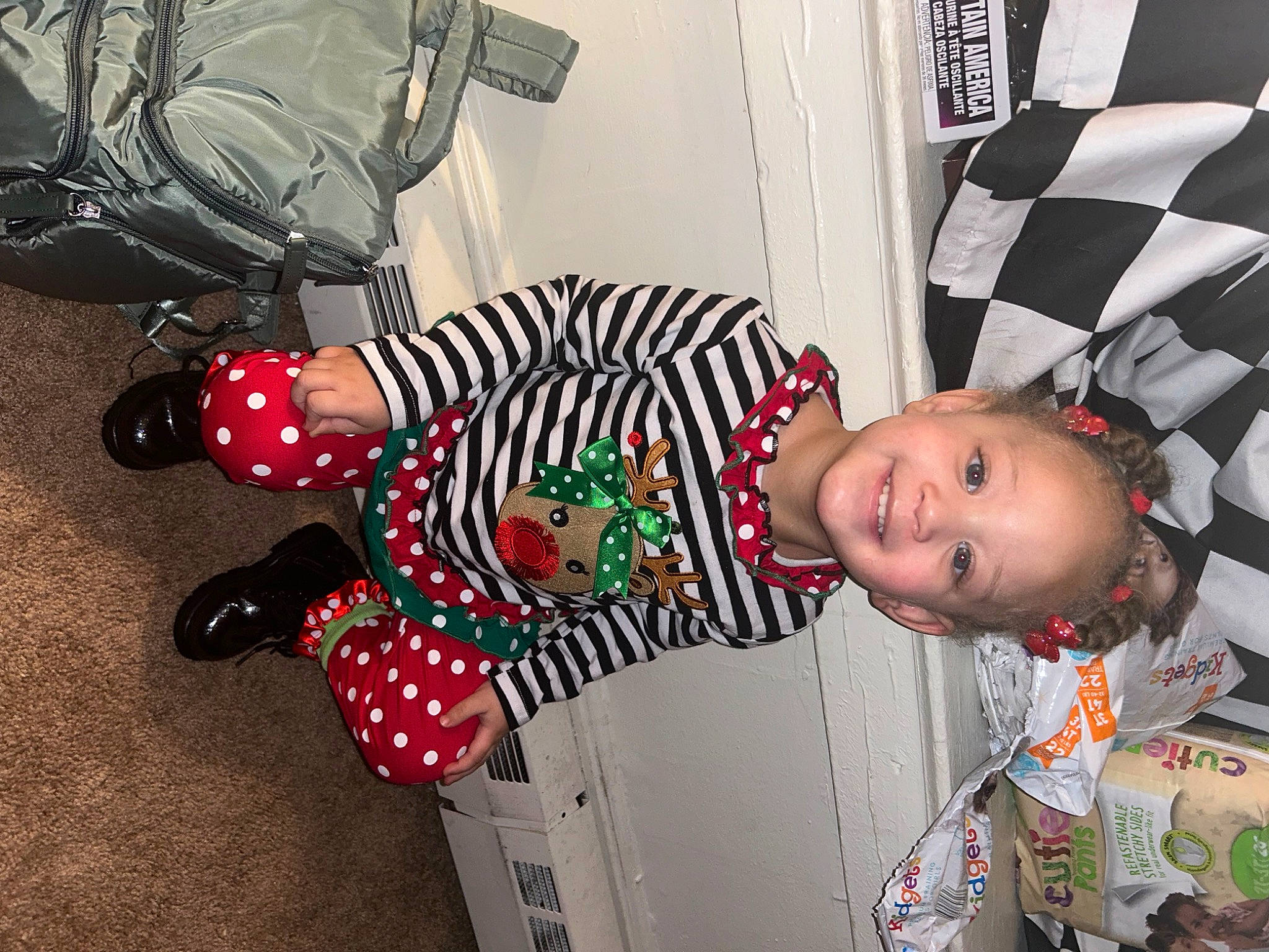 Anora is registered to the contest to win money with this photo: baby, baby_toddler_clothing, bag, carmine, child, cool, costume, event, fun, hat, holiday, joy, luggage_and_bags, pattern, person, room, sleeve, textile, toddler