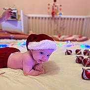 Alexia participe au concours pour gagner de l'argent avec cette photo : baby, bed, blanket, child, christmas, crib, cute, festive, holiday, holiday_decor, indoors, infant, nursery, ornaments, red_clothing, santa_hat, smiling, soft_lighting, string_lights, tummy