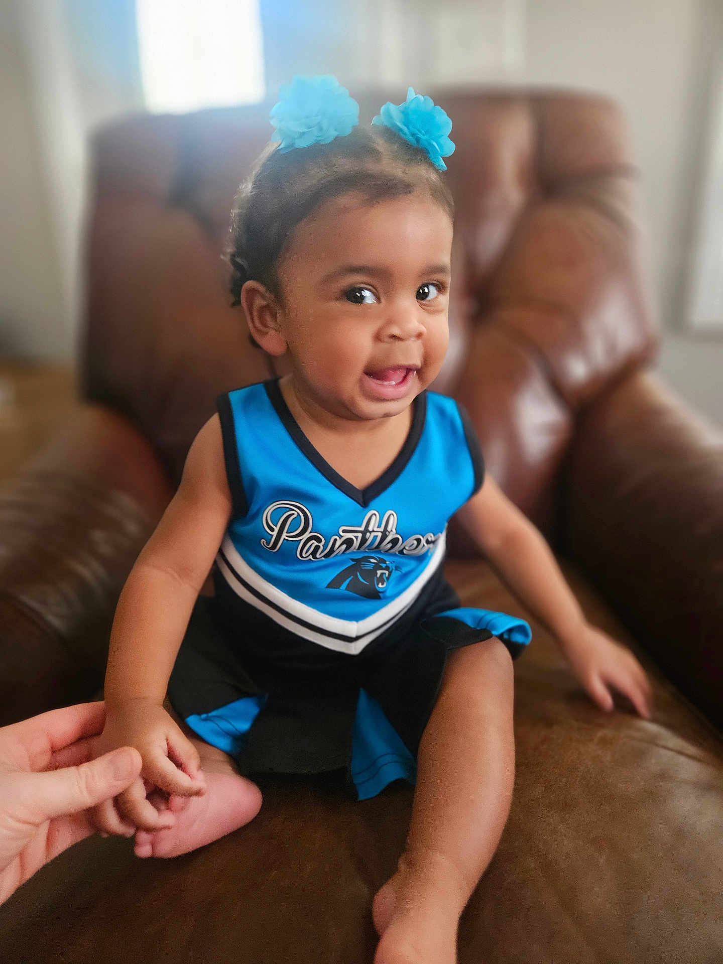 Nicole joined the competition — help win amazing prizes! toddler, child, smiling, blue, black, cheerleading_outfit, hair_clips, hand_holding, leather_chair, indoor, happy, person, cute, baby, portrait, sitting, skin, furniture, young_child, expression