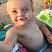 Elias joined the competition — help win amazing prizes! baby, baby_seat, blue_eyes, child, closeup, colorful, concrete, cute, happy, infant, outdoor, playful, portrait, shirtless, sitting, smiling, summer, sunlight, toy, young_child