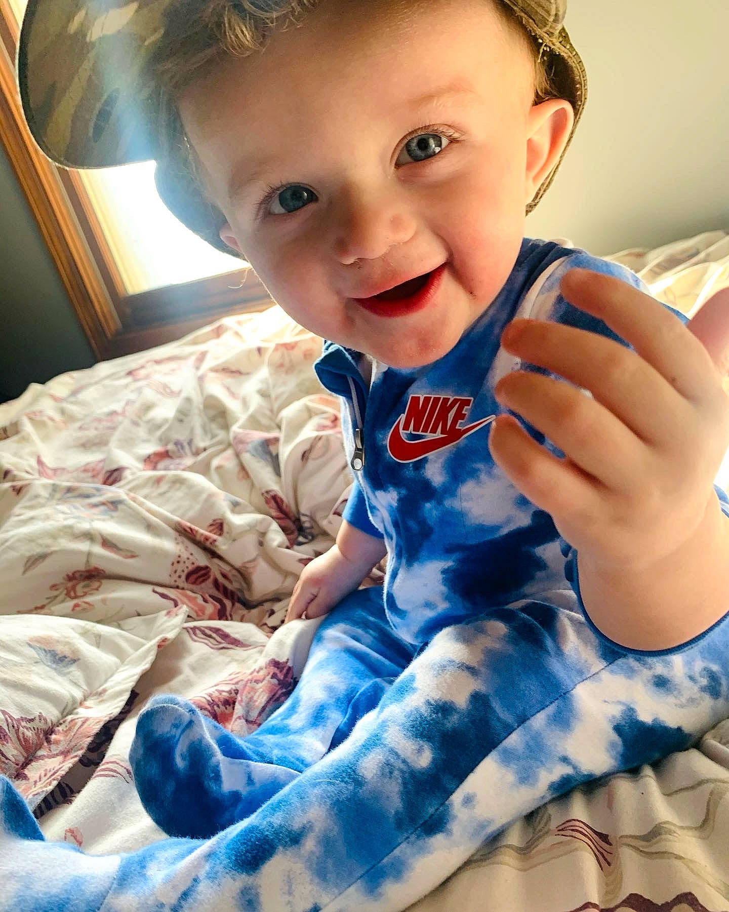 Colin is registered to the contest to win money with this photo: arm, baby_toddler_clothing, blue, child, cool, eye, finger, gesture, hairstyle, hand, happy, iris, organ, person, photograph, skin, sleeve, smile, t_shirt, toddler