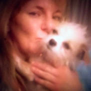 Twinky joined the competition — help win amazing prizes! person, dog, pet, blurred, out_of_focus, selfie, close_up, hand, fur, face, eyes, nose, cuddle, affection, indoor, portrait, low_light, soft_focus, warm_tone, cozy