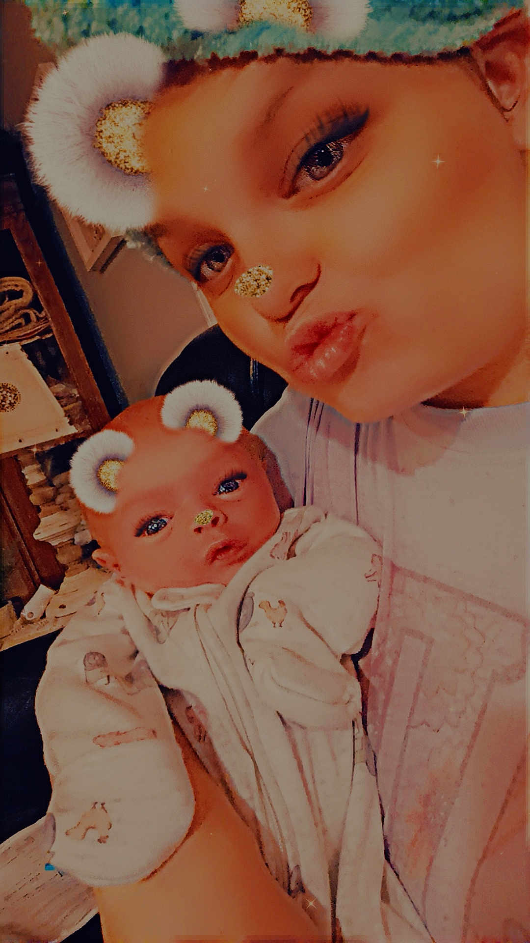Laeton is registered to the contest to win money with this photo: baby, person, face, closeup, selfie, sparkle_filter, bear_ears, glitter_nose, cute, indoor, clothing, eyelashes, head, holding, infant, warm_lighting, soft_focus, expression, portrait, family