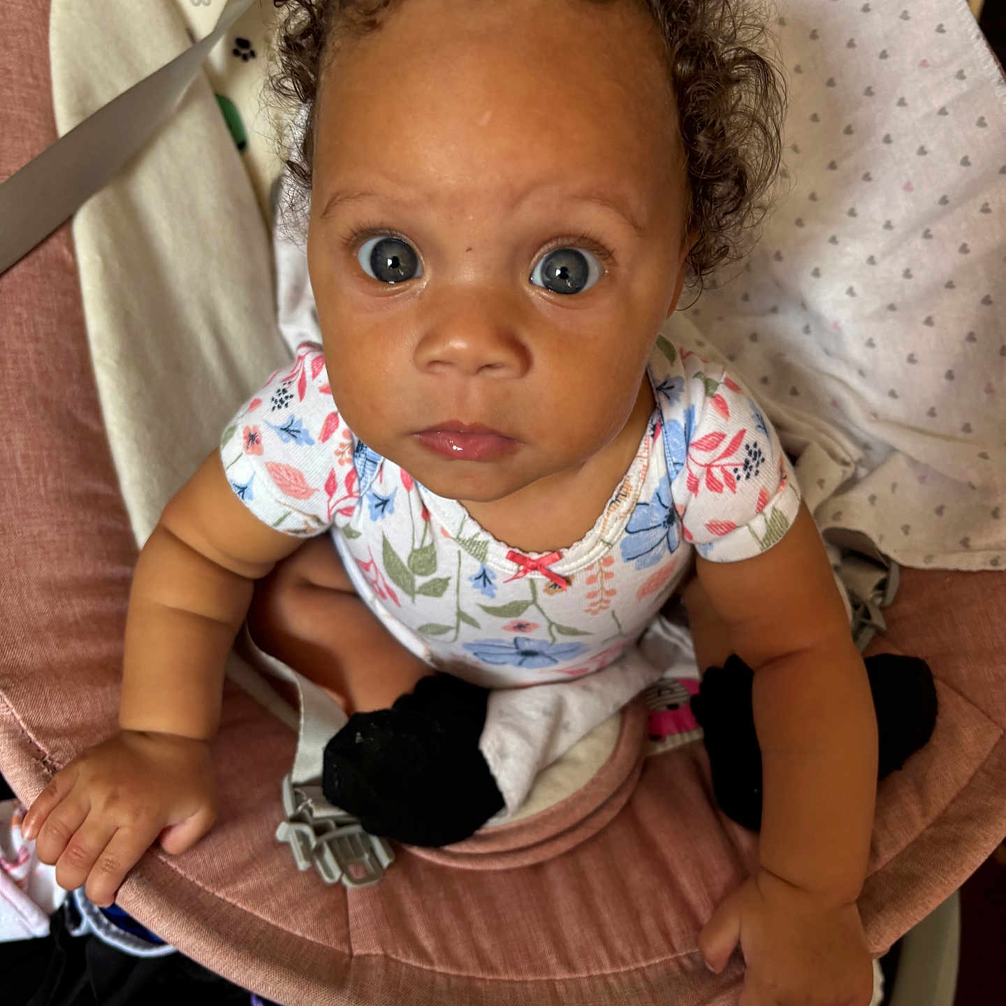Londyn joined the competition — help win amazing prizes! baby, baby_seat, blanket, blue_eyes, child, closeup, curly_hair, cute, expression, fabric, footwear, hand, indoor, infant, looking_up, onesie, person, portrait, sitting, soft_toy