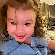 Paisley is registered to the contest to win money with this photo: blonde, child, clothing, couch, cushion, dress, face, female, furniture, girl, hair, happy, head, homedecor, laughing, pants, person, photography, portrait, smile