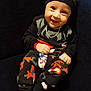Yuvansh is registered to the contest to win money with this photo: baby, bear_ears, black_clothing, chain, child, couch, cute, furniture, happy, hat, indoor, jewelry, pants, portrait, ring, seated, smiling, socks, spiderman, toddler