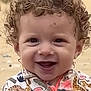 Oussaïd a rejoint le concours — aidez-le/la à gagner de superbes lots ! animal_print, baby, beach, bright, child, clothing, colorful_clothing, curly_hair, cute, face, happy, joyful, outdoor, person, playful, portrait, sand, smiling, toddler, young_child