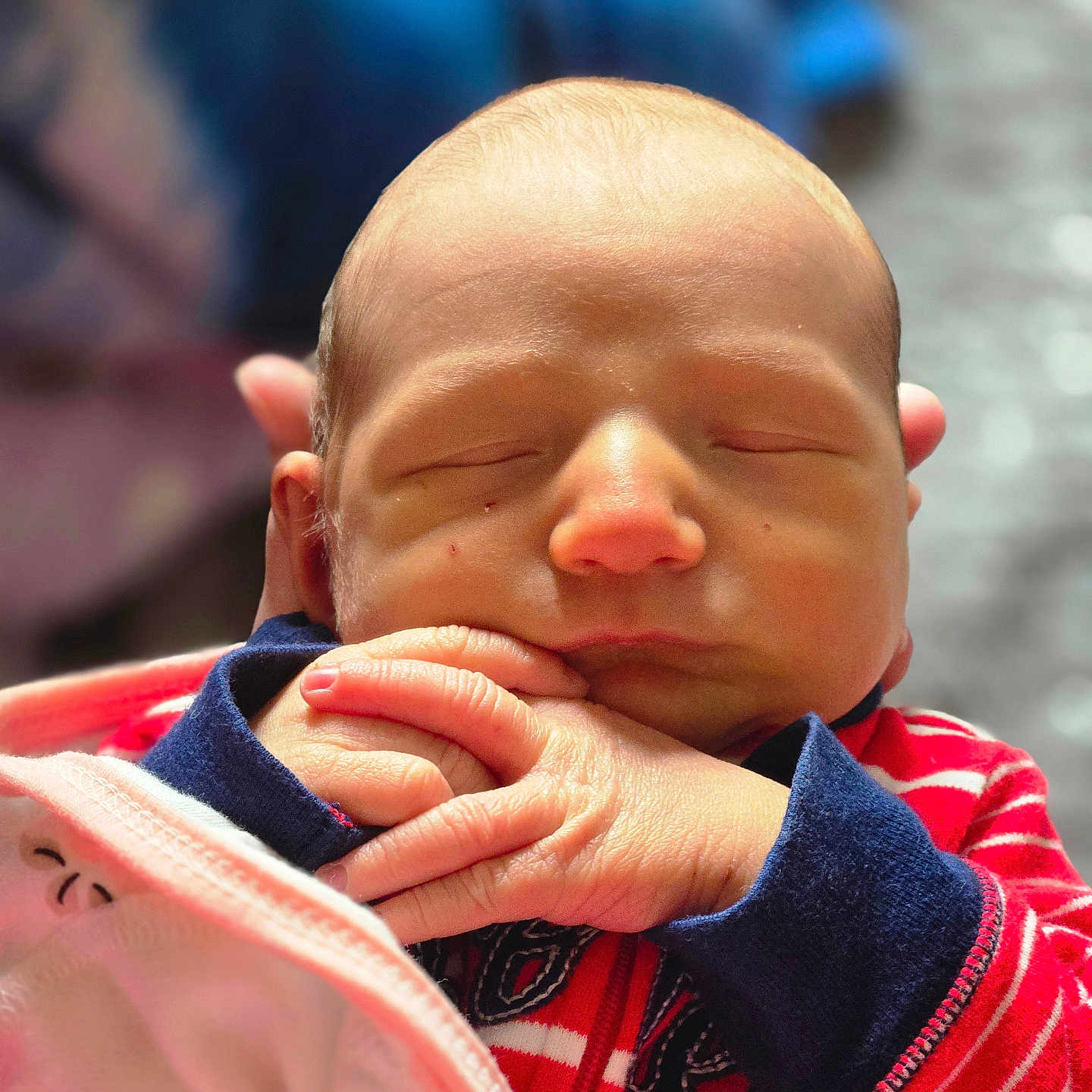 Thomas joined the competition — help win amazing prizes! baby, newborn, sleeping, hands, face, clothing, striped, red, navy_blue, blanket, infant, peaceful, portrait, closeup, skin, person, cute, indoors, soft_light, young_child
