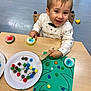 Ayden participe au concours pour gagner de l'argent avec cette photo : activity, art_project, chair, child, colorful, craft, floor, fun, green_paper, happy, indoor, person, plate, play, pom_poms, smiling, table, toddler, wooden_tool, young_child