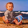 Ayden a rejoint le concours — aidez-le/la à gagner de superbes lots ! beach, bucket, child, cute, fun, hair, nature, ocean, outdoor, play, sand, sea, sitting, summer, sunlight, swimsuit, toddler, toy, water, waves
