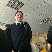 Jamal joined the competition — help win amazing prizes! child, student, school_uniform, classroom, indoor, ceiling_tiles, fluorescent_light, backpack, coat, bag, portrait, standing, group, profile, door, poster, tiles, sweater, crowd, expression