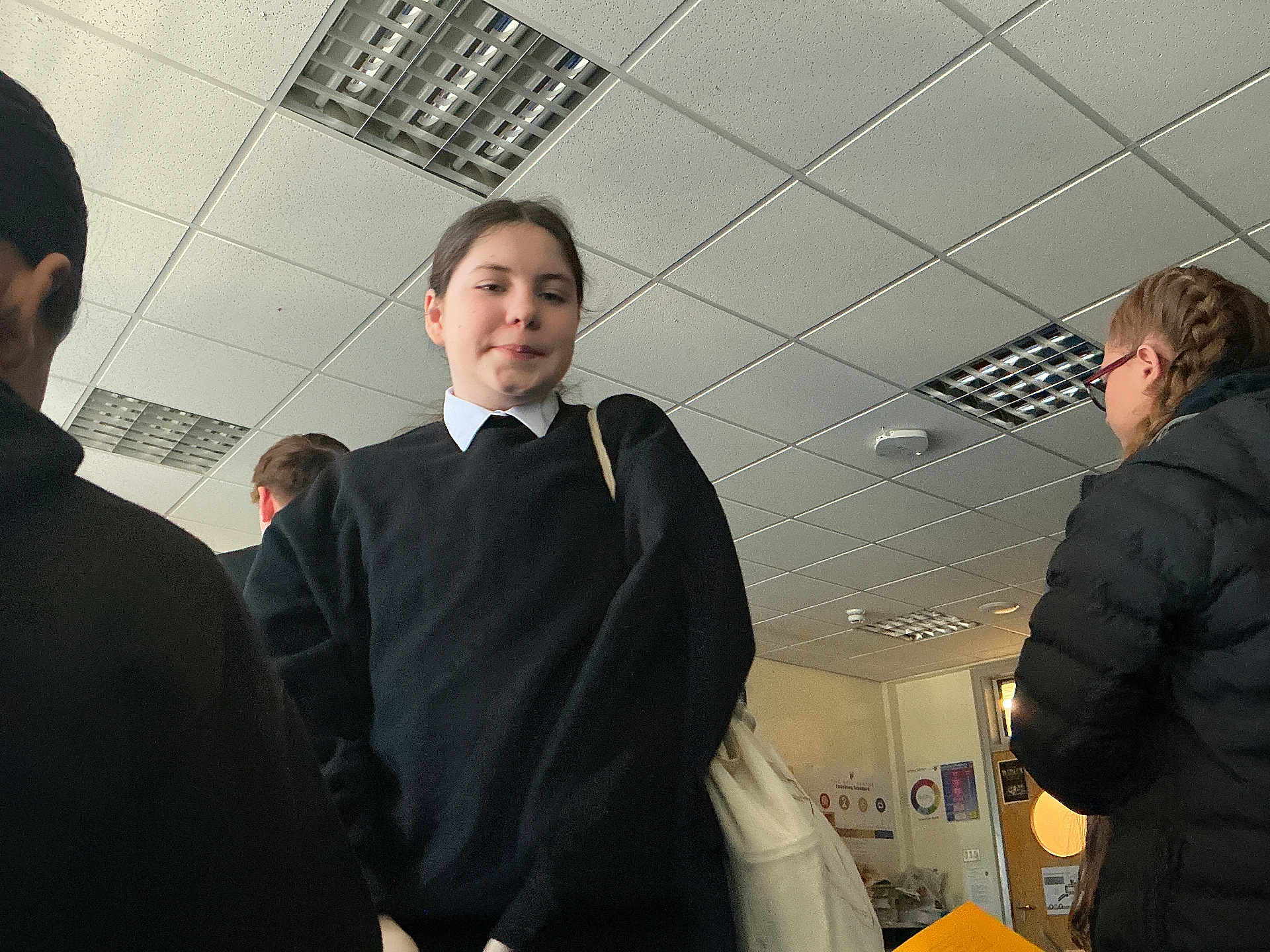 Jamal joined the competition — help win amazing prizes! child, student, school_uniform, classroom, indoor, ceiling_tiles, fluorescent_light, backpack, coat, bag, portrait, standing, group, profile, door, poster, tiles, sweater, crowd, expression