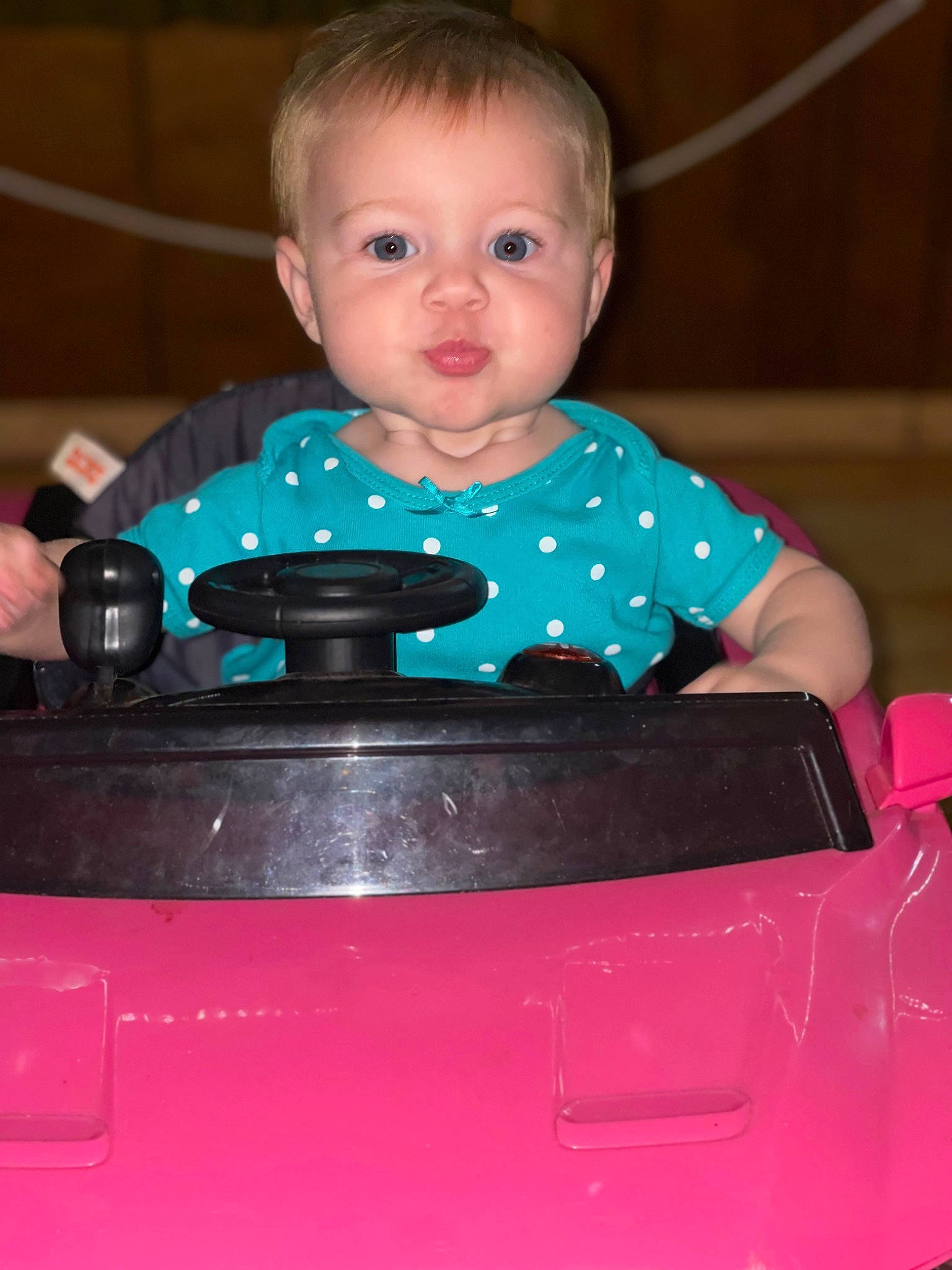 Lilliana is registered to the contest to win money with this photo: automotive_design, automotive_lighting, baby, baby_products, baby_toddler_clothing, bumper, cheek, child, chin, electric_blue, eyebrow, fun, happy, iris, person, plastic, sitting, sleeve, t_shirt, toddler