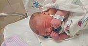 Elena joined the competition — help win amazing prizes! newborn, baby, infant, hospital, blanket, pacifier, bracelet, sleeping, bed, bassinet, person, skin, hand, face, cute, resting, hospital_room, clothing, wrapped, peaceful