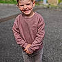 child, smiling, outdoor, sweatshirt, pants, happy, boy, casual_clothing, playground, gravel, portrait, cute, young, standing, fashion, person, hair, face, expression, daylight