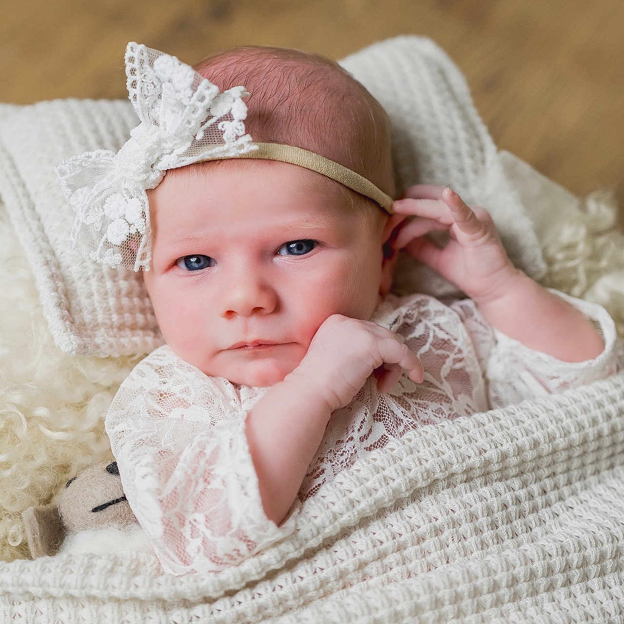 Mavie joined the competition — help win amazing prizes! baby, blanket, blue_eyes, calm, cozy, cute, expression, face, hand, headwear, indoors, infant, lace_headband, newborn, pillow, portrait, resting, skin, sleeping_area, soft_texture