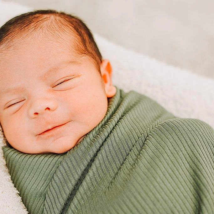 Mason joined the competition — help win amazing prizes! newborn, baby, infant, sleeping, smiling, wrapped, blanket, green_blanket, closeup, face, peaceful, soft_light, cozy, resting, portrait, cute, child, fresh, toddler, bed