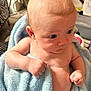 baby, infant, blue_towel, diaper, skin, arm, hand, face, eyes, ear, indoor, fist, expression, curious, person, child, newborn, blanket, closeup, soft