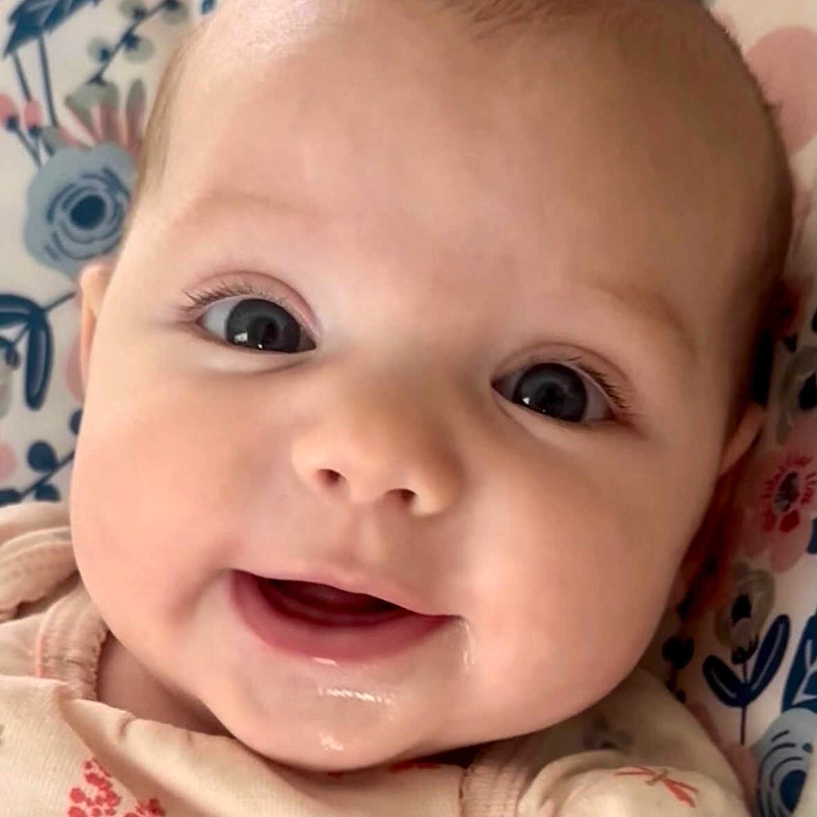 Sophia joined the competition — help win amazing prizes! baby, cheeks, child, close_up, clothing, cushion, cute, expression, eyes, face, floral_pattern, happy, indoors, infant, mouth, person, portrait, skin, smile, young