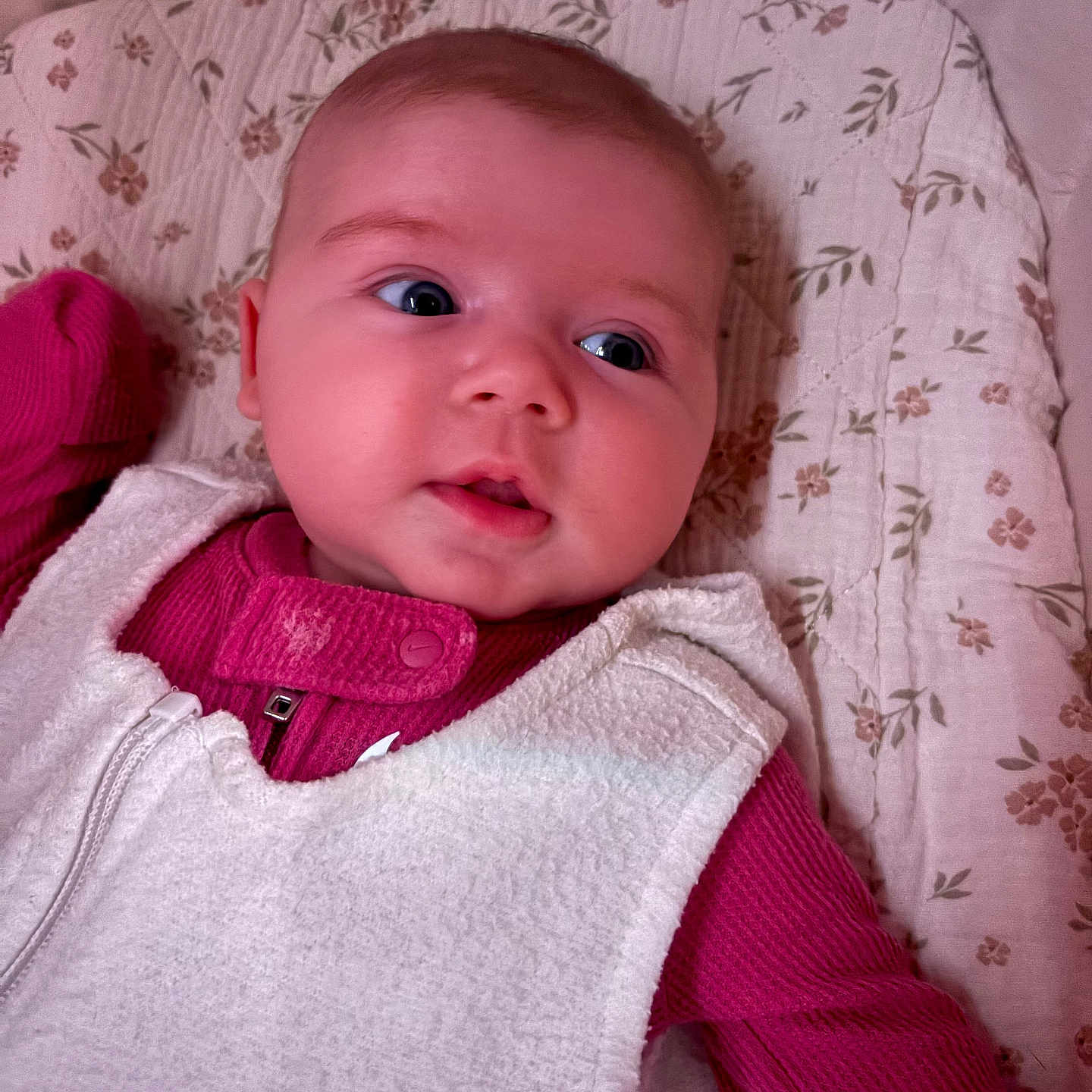 Dylan joined the competition — help win amazing prizes! baby, infant, child, face, portrait, clothing, vest, pink, white, quilt, floral_pattern, lying_down, skin, cute, indoors, cozy, expression, head, human, young