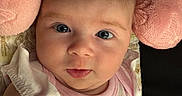 Dylan joined the competition — help win amazing prizes! baby, blanket, child, closeup, clothing, comfort, cute, expression, eyes, face, head, indoors, infant, newborn, person, pink_pillow, portrait, resting, skin, soft_texture